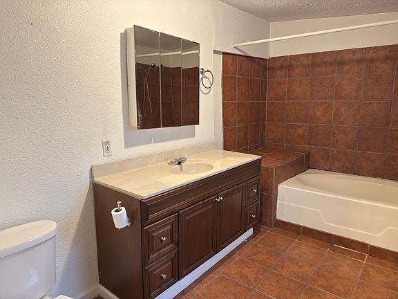 Standing in bathroom doorway