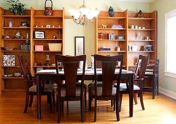 Dining room with large window and built in book shelves