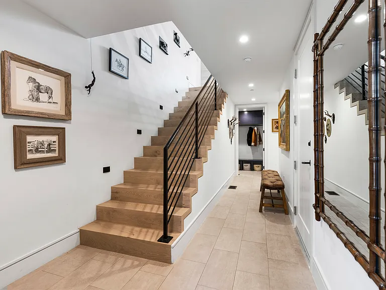 Entry from street. Mudroom with laundry (second full laundry on 3rd level). Interior door to private garage on right.