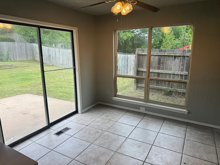 Dining area, ceiling fan, patio sliding doors.