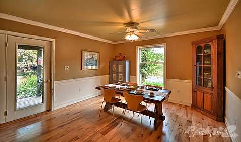 Dining area has French doors leading to the side porch overlooking the first of two Koi ponds
