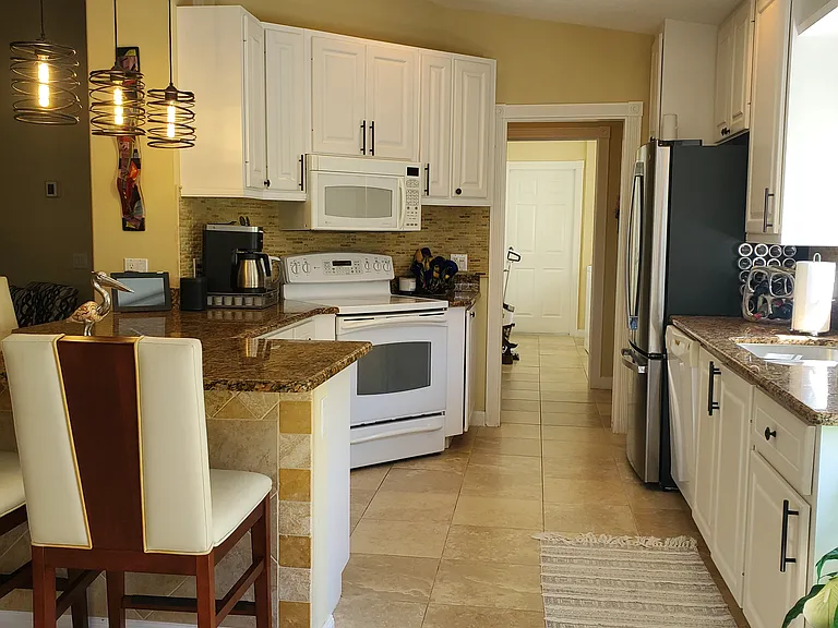 Dining room facing kitchen and laundry room