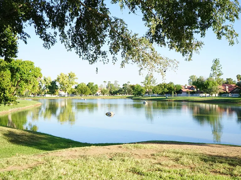 Lake across the street with lighted walking path.