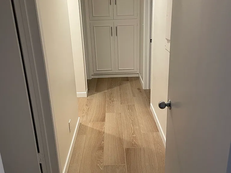 hallway to three bedrooms and 2 bathrooms