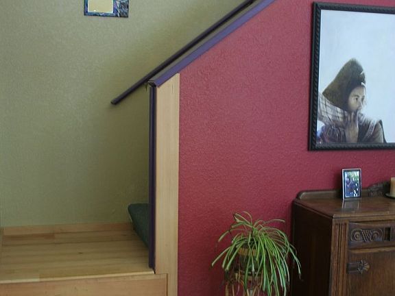 Stairs up to small bedroom