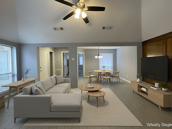 Another sample virtual staging of the living room looking into the dining room and behind the column support the kitchen.