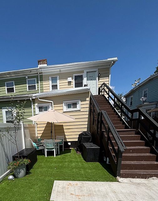 The private entrance steps lead you to your new home, showcasing the dedicated dining, grilling, and playing no-maintenance lawn area.