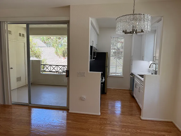 View of patio and kitchen from front door entry.