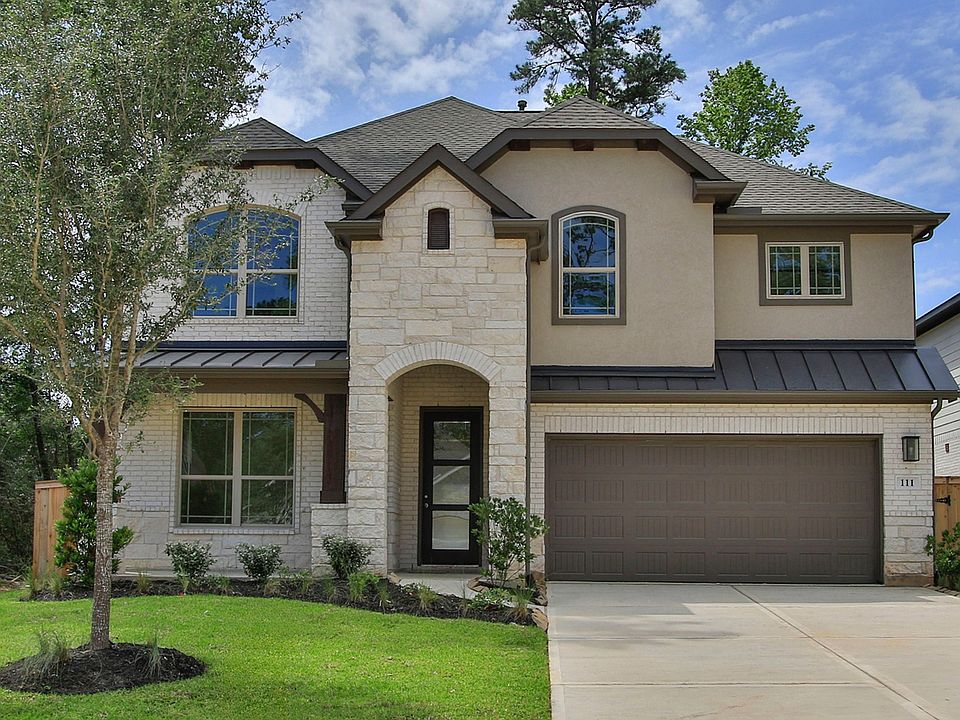 Lavish stone facade and arched entry grace this refined home in The Woodlands Hills, exuding timeles