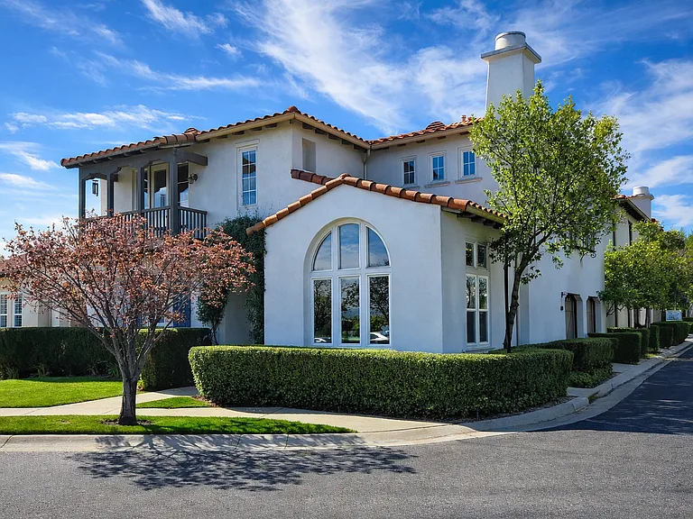 Beautiful Spanish-style home in prestigious gated Woodlands community with prime corner location and excellent curb appeal. Steps away from Valencia Town Center
