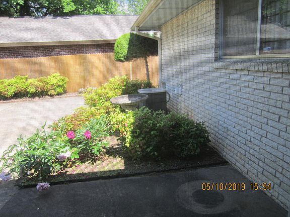 Back flower bed with bird bath that stays