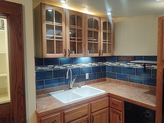 Kitchen cabinets, a sink with a touch faucet and look at that gorgeous tiling! Oh, don't forget the dishwasher in the lower right of the picture.