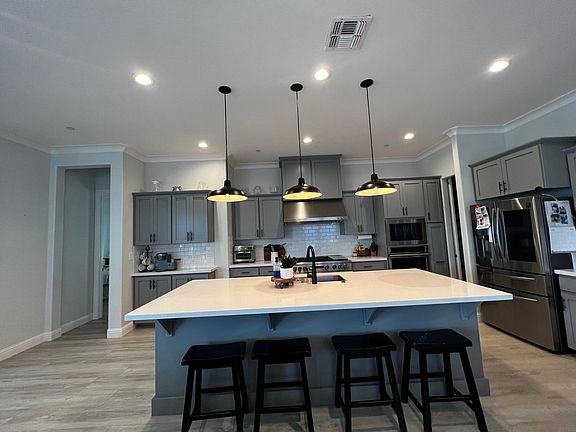 Beautiful open kitchen with large island, GE monogram appliance and Samsung Smart Refrigerator, walk in Pantry and plenty of storage!