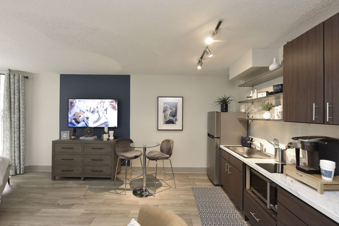 Kitchen with quartz counters, modern cabinetry, and stainless appliances
