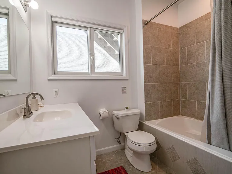 Second story bathroom shared by two bedrooms and guests. Laundry center closet right outside bathroom in hall.