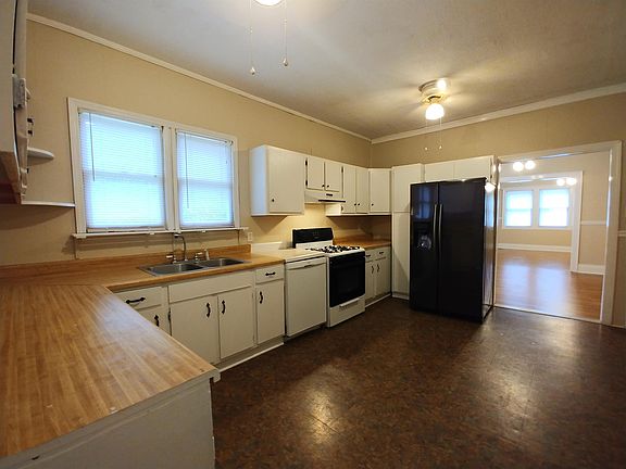 large kitchen with gas stove, side-by-side refrigerator, and dishwasher