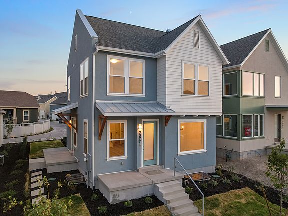 Two-story modern house from the Contempo Collection with gray and white exterior, large windows, fro