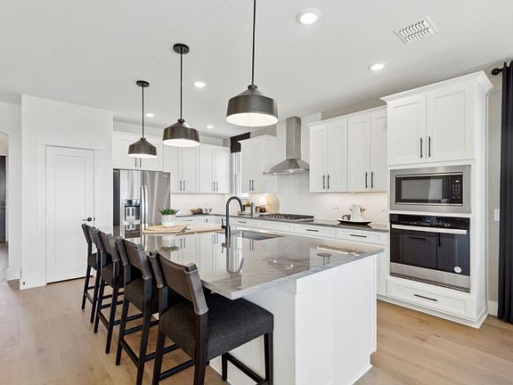Open-concept kitchen with pendant lighting