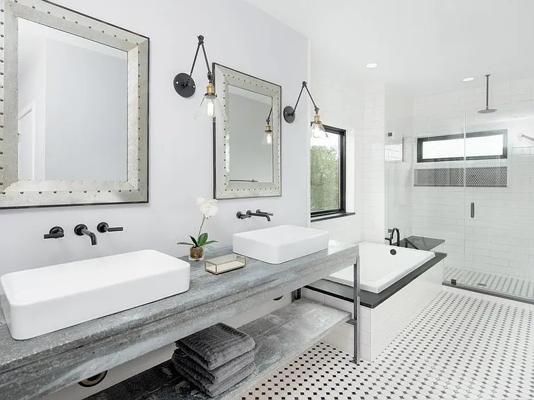 This stunning primary bathroom blends modern industrial design with spa-like comfort.