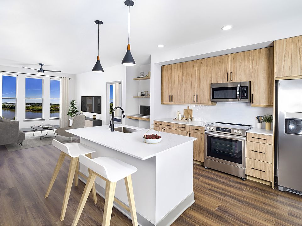 Luxuriate in unparalleled elegance at Modera Riverview with single-basin sinks, stylish tile backsplash, and ENERGY STAR_ stainless steel appliances.