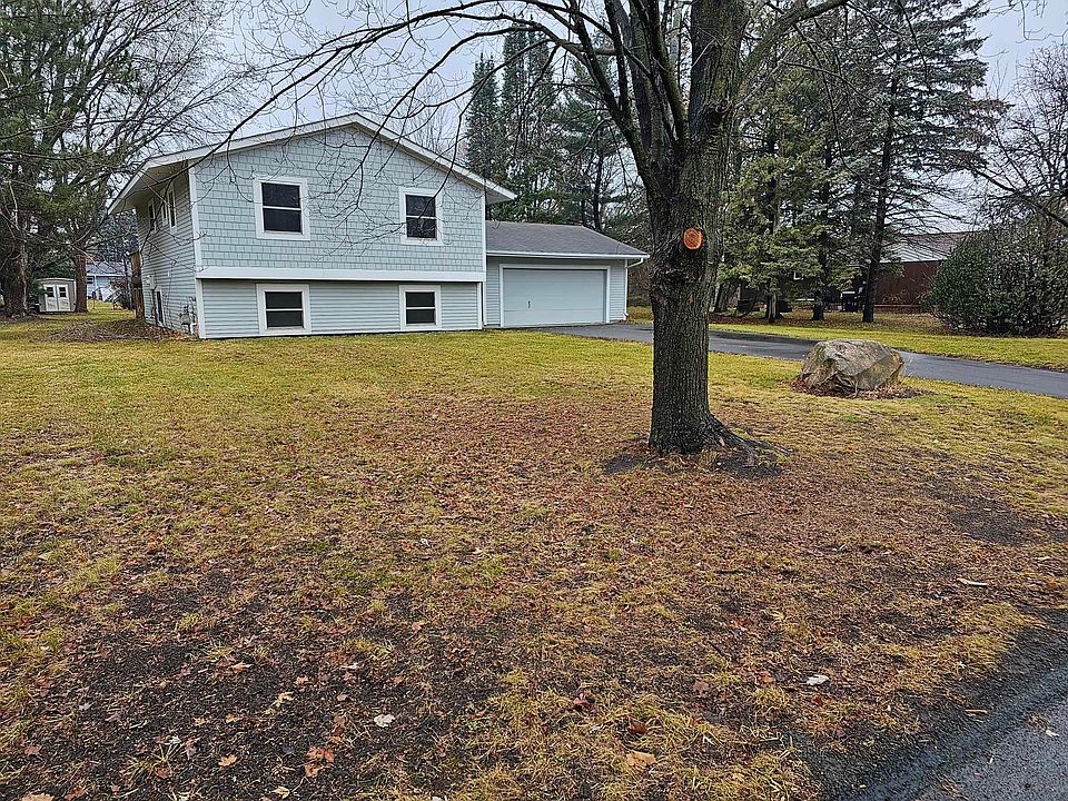 Charming front exterior surrounded by mature trees, offering a peaceful and private setting.