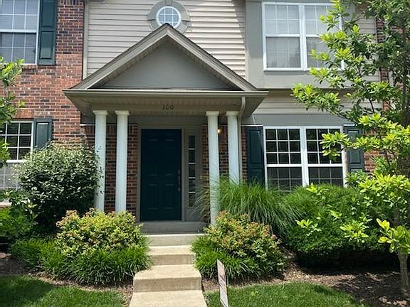 Outside of the property. Stairs lead to the townhouse.