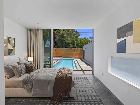 Primary bedroom overlooking pool oasis