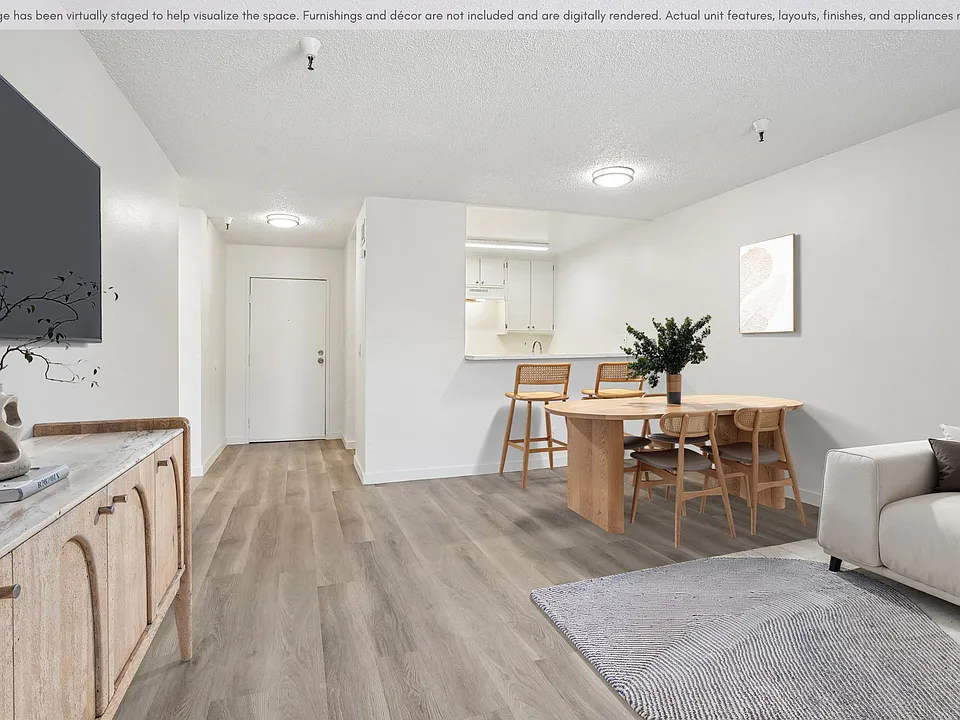 Open living and dining space featuring modern flooring and a seamless layout.