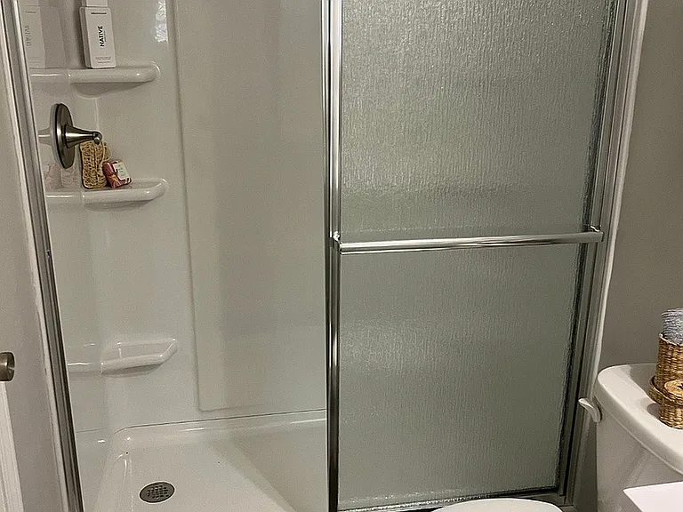A spacious, brand new walk-in shower designed for everyday comfort.