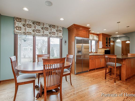 Kitchen includes all stainless steel appliances, island and breakfast room.