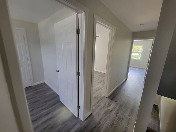 Upstairs hallway opens to three bedrooms and bathroom.