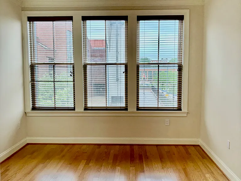 Bedroom w/ Wall of Windows and LED Ceiling Fan.