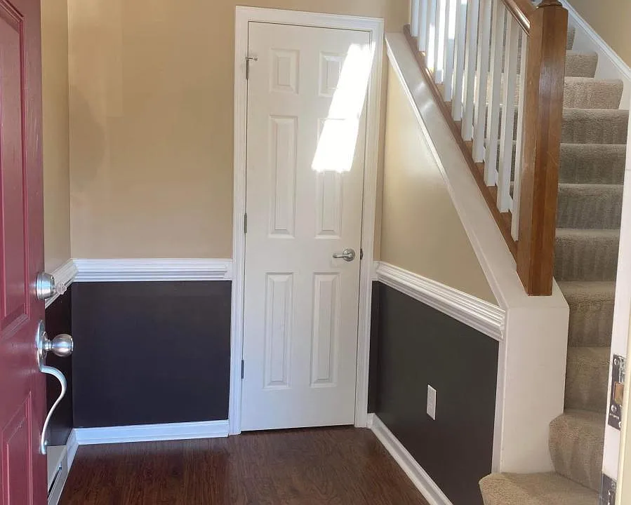 Entryway with wood floors and coat closet.