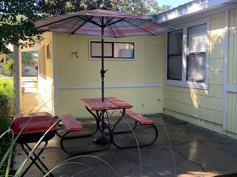 Back patio with outdoor shower, charcoal grill