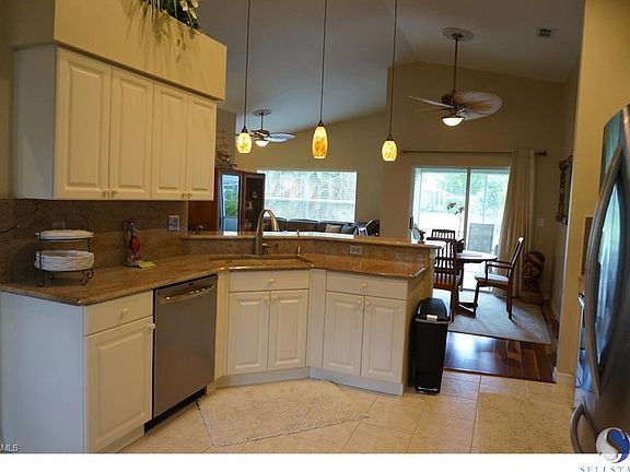 Very open floorplan with a large screened lanai, master bedroom split from guest suite, large back yard with plenty of room for a pool, cathedral ceiling, and deluxe ceiling fans.