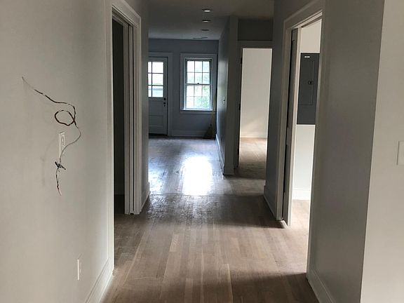 This hallway leads to the back of the house. The wires on the left side of hallway are where the Nest thermostat lives now. That open space farther along on the left wall is an enormous closet. On the right side of the hall is a bonus room. It can't le