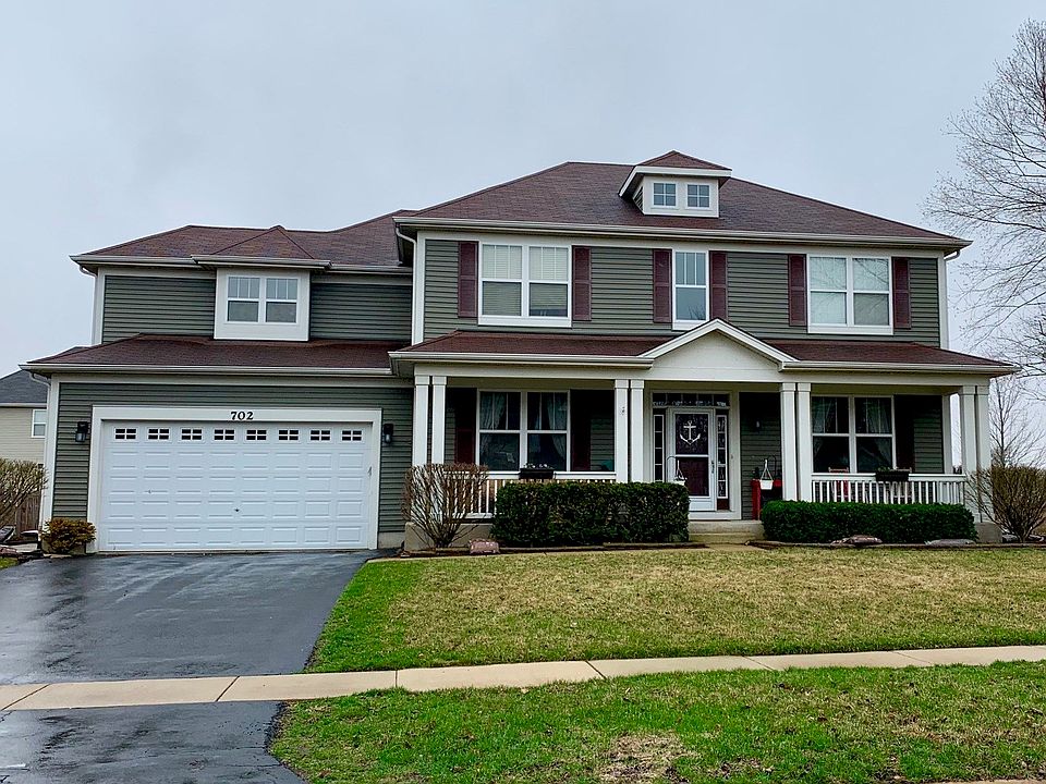 Charming home on a corner lot with full front porch and tandem 3 car garage.