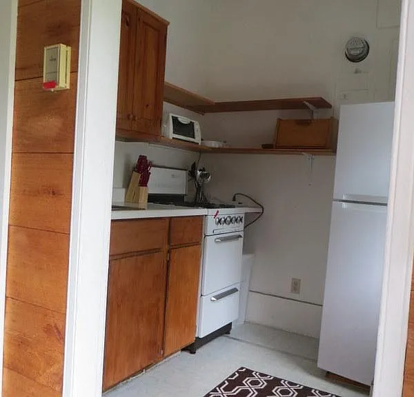 Entry from front door; Steep stairs on left go upstairs and kitchen is to right . I am standing in entrance on first floor. Outside front door is parking in front of house and apartment.