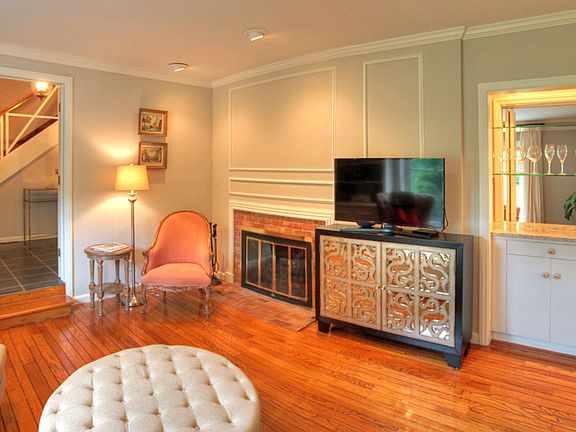 A fireplace in the corner and a wet bar with a quartz countertop complete this room.