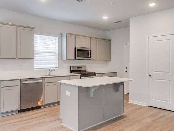 Longspur Kitchen with soothing light grey cabinets.