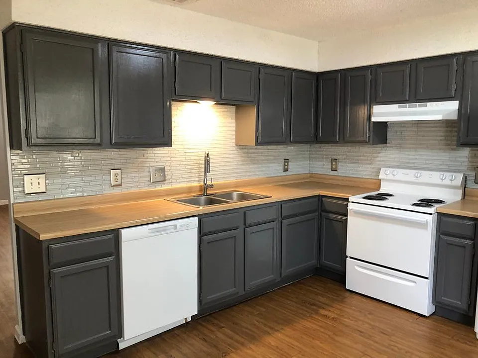 Kitchen with new glass back splash, freshly painted cabinets, new dishwasher