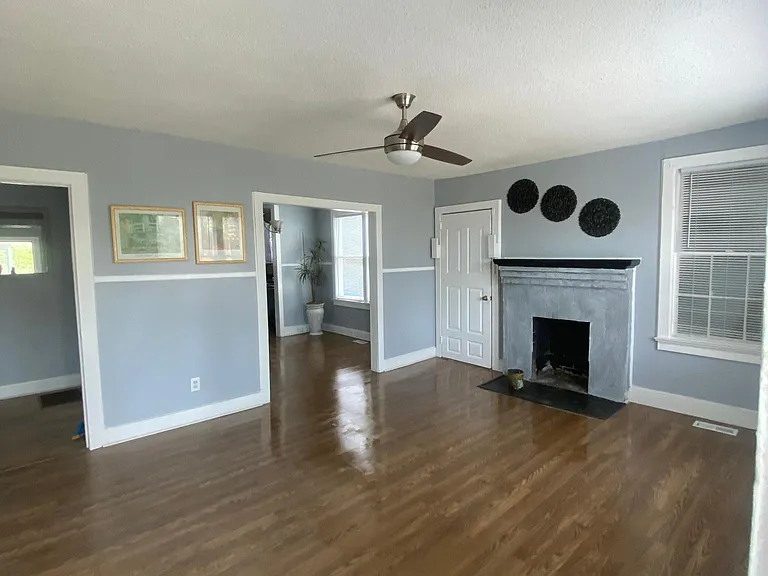 Open concepts, living room, dining room, living room with fireplace, ceiling, fans in living room, dining room, and kitchen