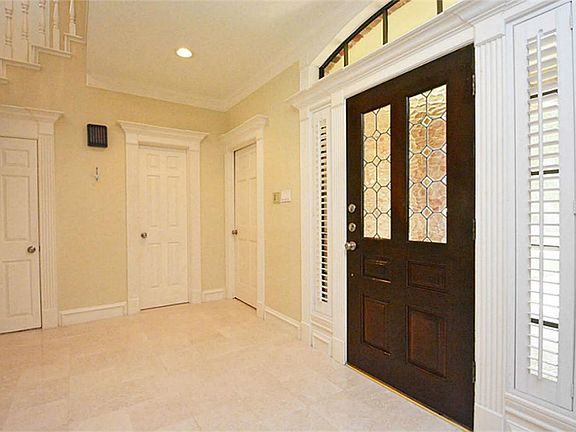BEAUTIFUL LEADED GLASS FRONT DOOR, TRANSOM WINDOW, FLUTED MOLDINGS, PLANTATION SHUTTERS, RECESSED LI