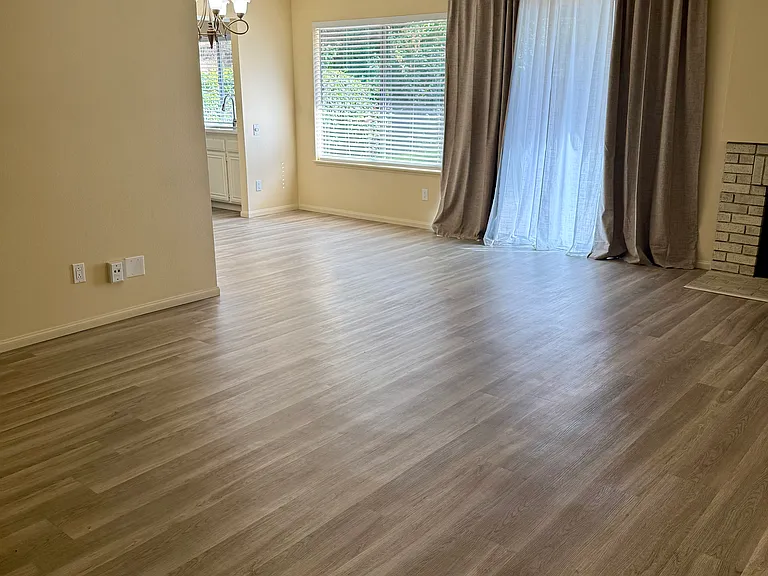 Main Living room, leading into dining nook, slider for backyard access and bright window for lots of natural light.