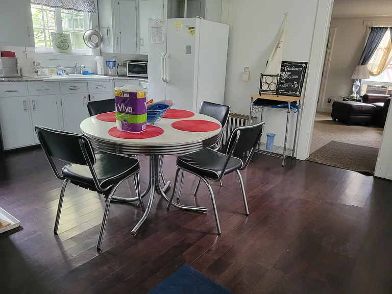 BIG Eat in Kitchen. Sunny with windows. LARGE Washer and Dryer. French door Fridge. Granite counters. 1920 Barn Find Farm Sink with Apron. Dark Hardwoods. Leads to covered patio overlooks big grassy back yard with mature trees. Fenced patio-small yard.
