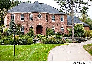 Enter this exquisite home w/circular driveway to brick exterior