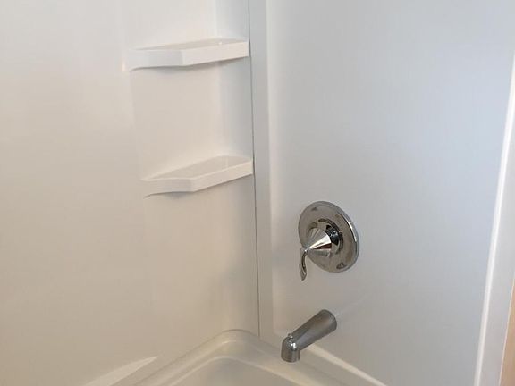 Upstairs bath - tub with shower surround