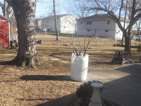 FENCED BACKYARD WITH STORAGE SHED