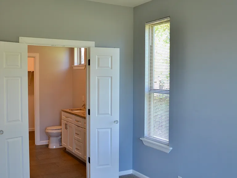 master bedroom looking into bathroom and closet beyond