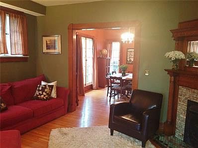 Charming entryway with original light fixture opens to kitchen and living room.